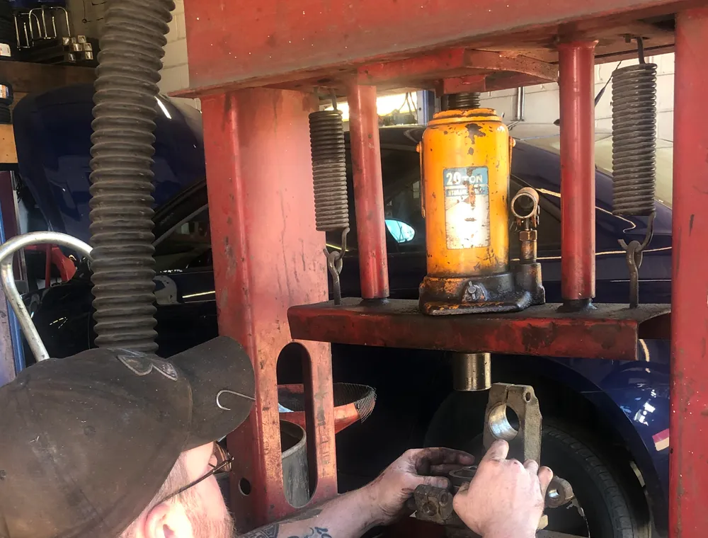 An ASE-certified technician at work in the shop